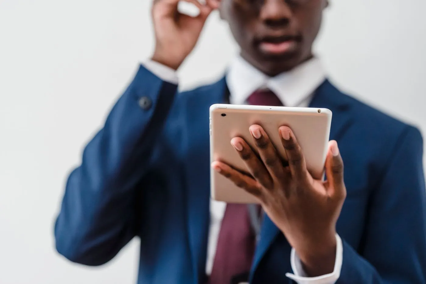 Business professional reviewing management software on a tablet